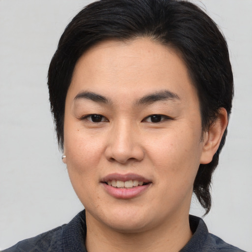 Joyful asian young-adult female with medium  brown hair and brown eyes