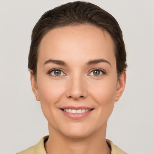 Joyful white young-adult female with short  brown hair and brown eyes