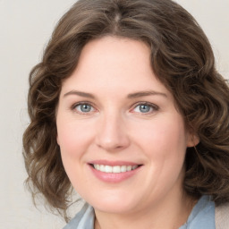 Joyful white young-adult female with medium  brown hair and blue eyes