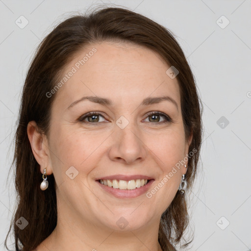 Joyful white adult female with long  brown hair and grey eyes