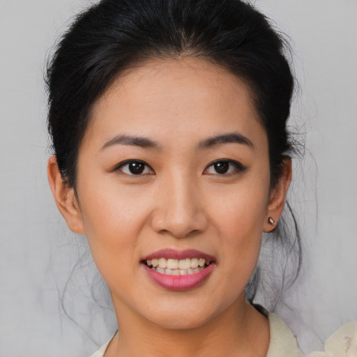 Joyful asian young-adult female with medium  brown hair and brown eyes