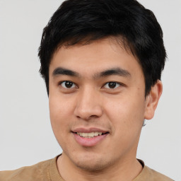 Joyful asian young-adult male with short  black hair and brown eyes