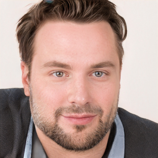 Joyful white young-adult male with short  brown hair and blue eyes