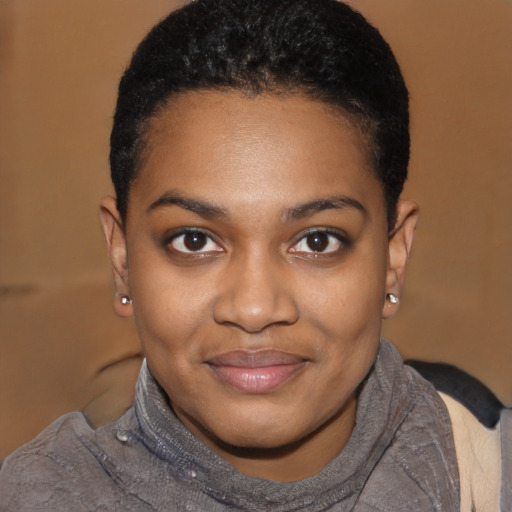 Joyful black young-adult female with short  black hair and brown eyes