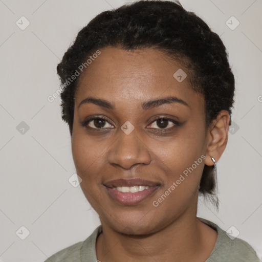 Joyful black young-adult female with short  black hair and brown eyes