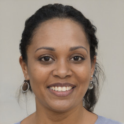 Joyful black young-adult female with medium  brown hair and brown eyes