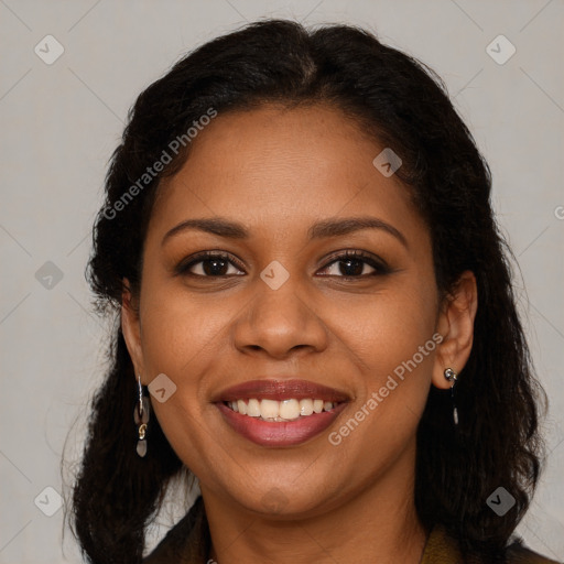 Joyful black young-adult female with long  brown hair and brown eyes