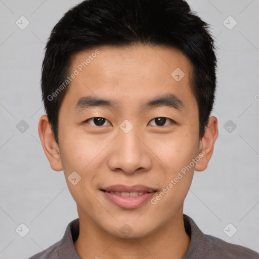 Joyful asian young-adult male with short  brown hair and brown eyes