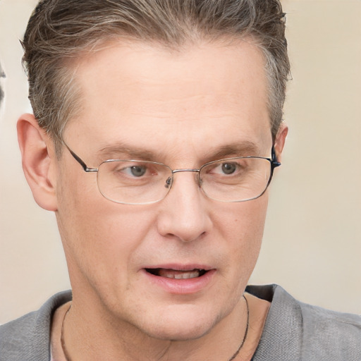 Joyful white adult male with short  brown hair and grey eyes