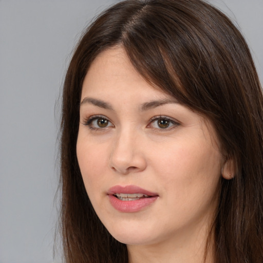 Joyful white young-adult female with long  brown hair and brown eyes