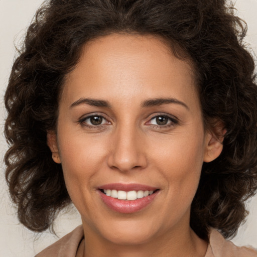 Joyful white adult female with medium  brown hair and brown eyes