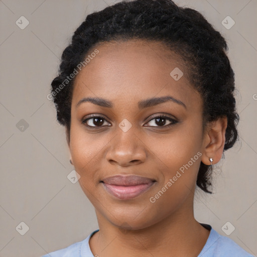 Joyful black young-adult female with long  black hair and brown eyes