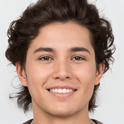 Joyful white young-adult male with medium  brown hair and brown eyes