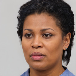 Joyful black adult female with short  brown hair and brown eyes