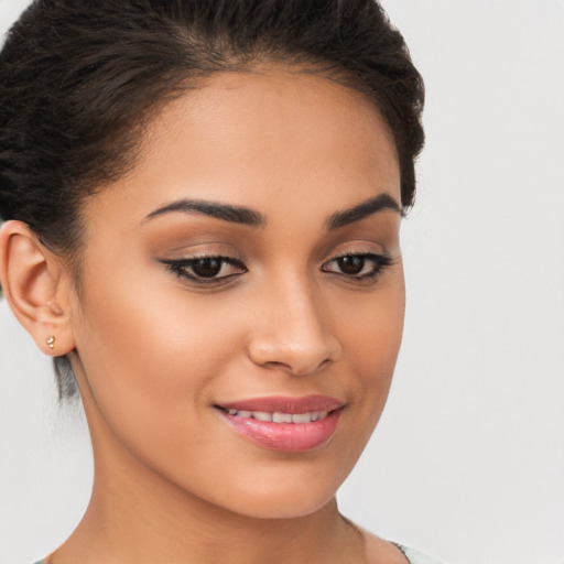 Joyful latino young-adult female with long  brown hair and brown eyes