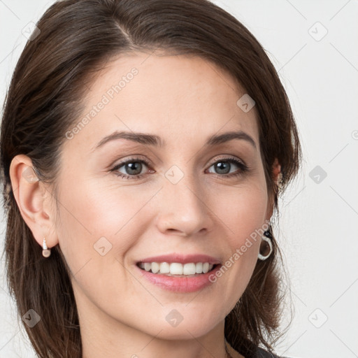 Joyful white young-adult female with long  brown hair and blue eyes