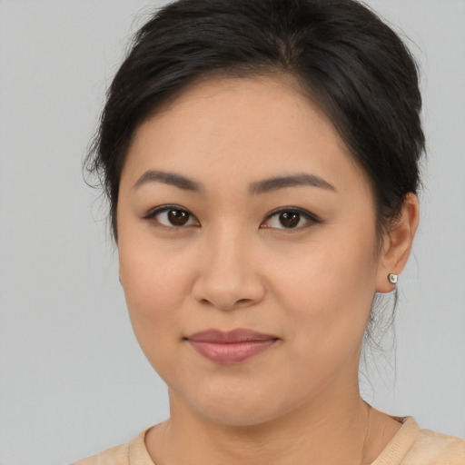 Joyful asian young-adult female with medium  brown hair and brown eyes