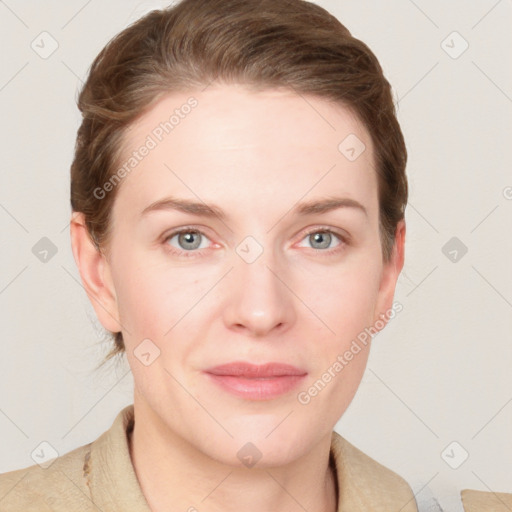 Joyful white young-adult female with short  brown hair and blue eyes