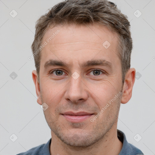 Joyful white adult male with short  brown hair and brown eyes