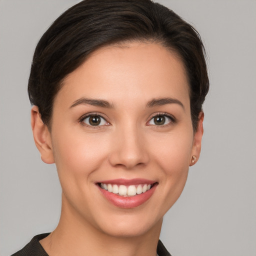 Joyful white young-adult female with short  brown hair and brown eyes