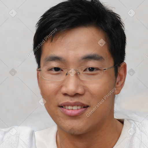 Joyful asian young-adult male with short  black hair and brown eyes