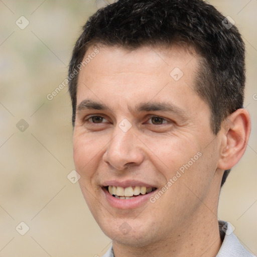 Joyful white adult male with short  brown hair and brown eyes