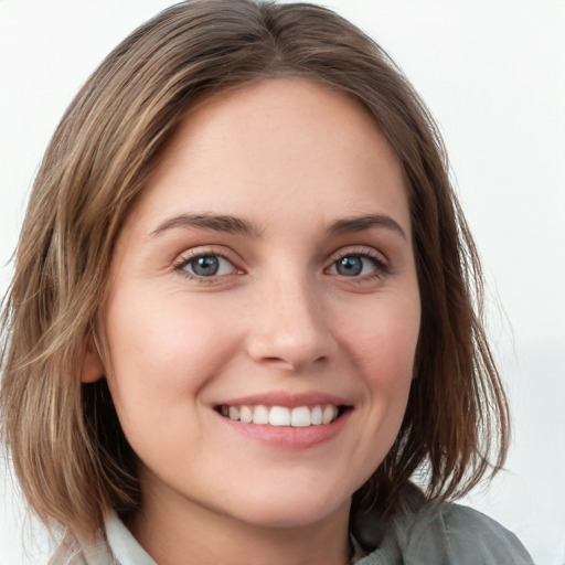 Joyful white young-adult female with medium  brown hair and blue eyes