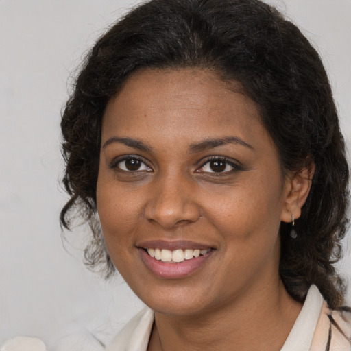 Joyful black young-adult female with medium  brown hair and brown eyes