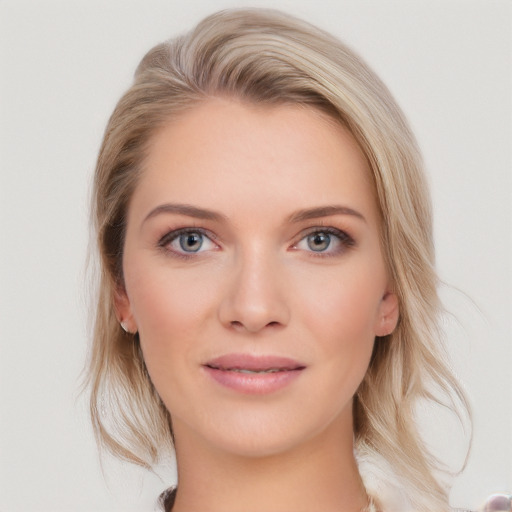 Joyful white young-adult female with medium  brown hair and blue eyes