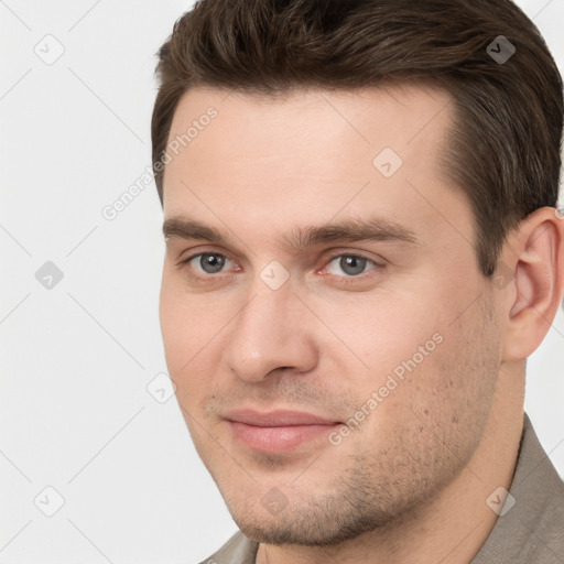 Joyful white young-adult male with short  brown hair and grey eyes