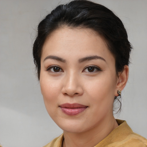 Joyful asian young-adult female with medium  brown hair and brown eyes