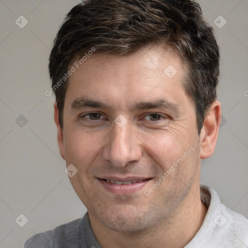 Joyful white adult male with short  brown hair and brown eyes