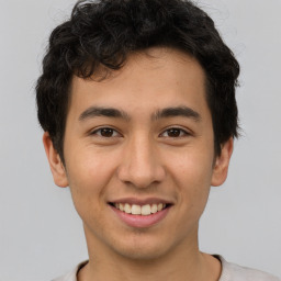 Joyful latino young-adult male with short  brown hair and brown eyes