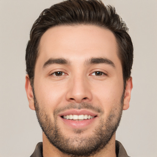 Joyful white young-adult male with short  black hair and brown eyes