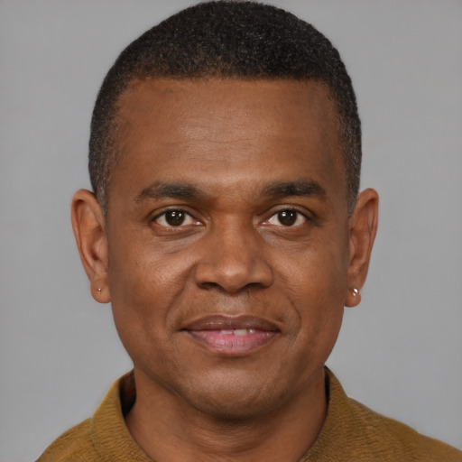 Joyful black young-adult male with short  brown hair and brown eyes