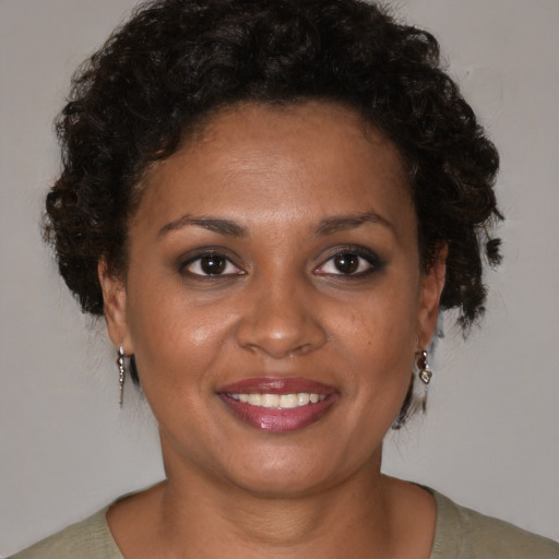 Joyful black young-adult female with short  brown hair and brown eyes