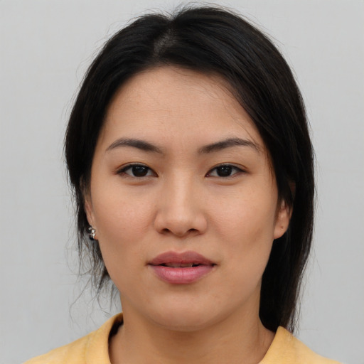 Joyful asian young-adult female with medium  brown hair and brown eyes