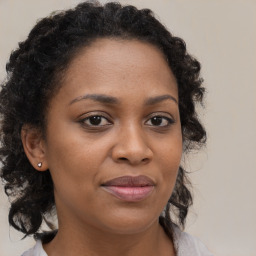 Joyful black young-adult female with medium  brown hair and brown eyes