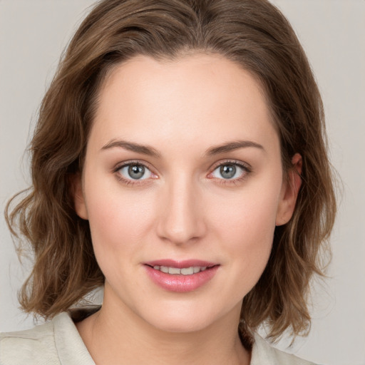 Joyful white young-adult female with medium  brown hair and green eyes