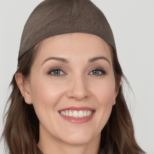 Joyful white young-adult female with long  brown hair and brown eyes