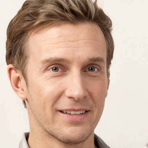 Joyful white adult male with short  brown hair and grey eyes