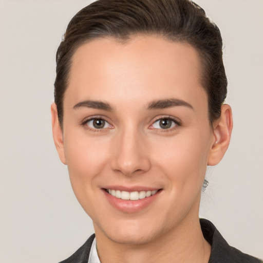 Joyful white young-adult female with short  brown hair and brown eyes