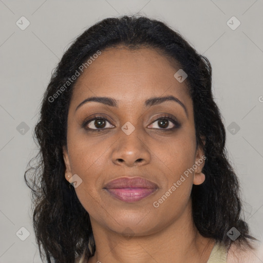 Joyful black young-adult female with long  brown hair and brown eyes