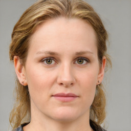 Joyful white young-adult female with medium  brown hair and blue eyes