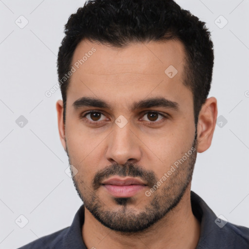 Neutral latino young-adult male with short  black hair and brown eyes