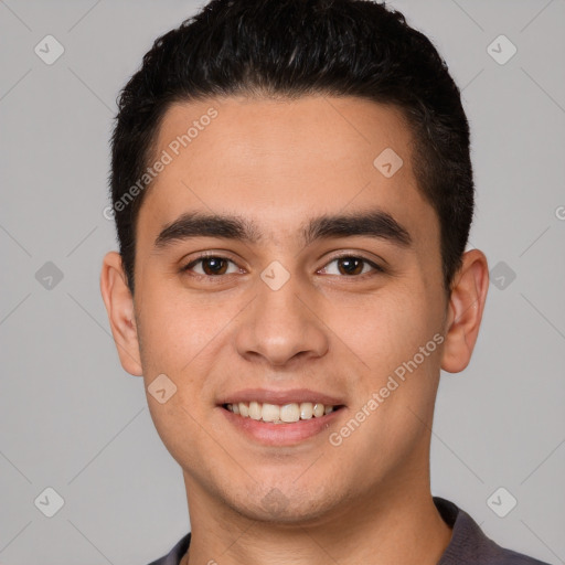 Joyful white young-adult male with short  black hair and brown eyes