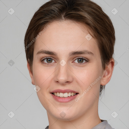 Joyful white young-adult female with short  brown hair and grey eyes