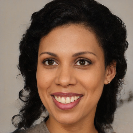 Joyful latino young-adult female with medium  black hair and brown eyes
