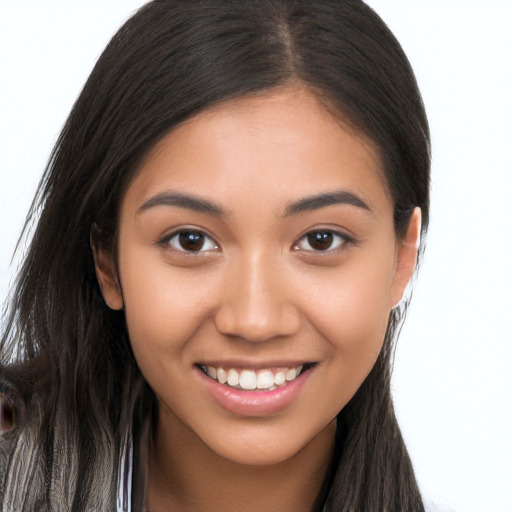 Joyful latino young-adult female with long  brown hair and brown eyes