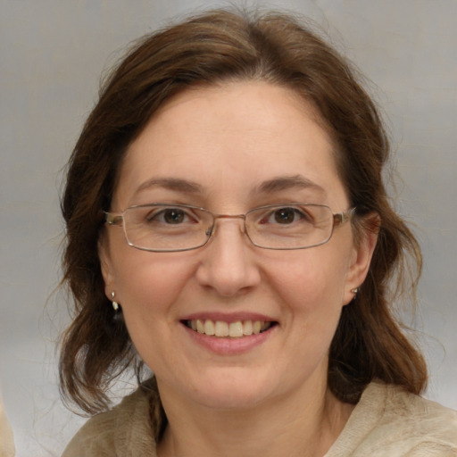 Joyful white adult female with medium  brown hair and grey eyes